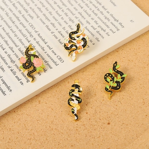 Set of four gothic snake enamel pins featuring flowers and daggers on gold metal