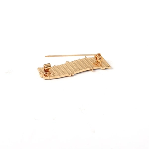 Golden music brooch back view with anti-slip texture and secure safety pin fastener