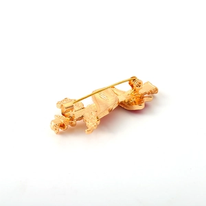 Creative Huabiao totem gold brooch showing back view with pin fastener on white background