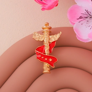 Golden Chinese ornamental column brooch with red enamel ribbon and five stars