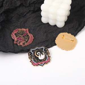 Detailed view of Gothic enamel badges with black rose and swan on gold metal base