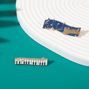 Detail of music badges featuring a black and white piano and a blue cat note design