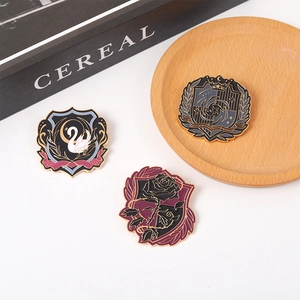 Detailed view of enamel badges featuring swan, rose, and nebula motifs on metal pins
