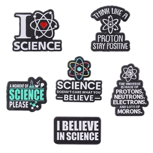 Set of six science themed enamel pins featuring atomic structures and positive slogans