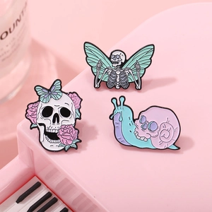 Pink gothic skull enamel pins set with butterfly, skeleton wings and snail badges