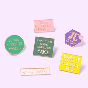 Detail of colorful geometric enamel pins with math formulas and humorous quotes