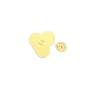 Back view of cute heart-shaped gold metal badge with butterfly clasp and matte texture