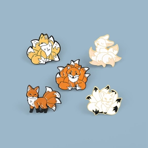 Set of five cute cartoon enamel fox pins with nine-tailed kitsune designs in orange