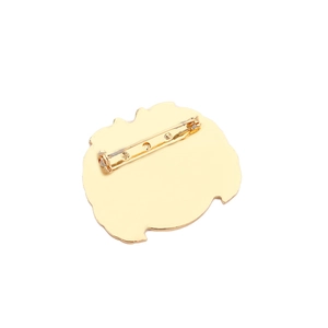 Golden earth shaped alloy brooch back view featuring a secure safety pin fastener