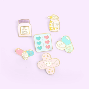 Enamel lapel pins set featuring cute cartoon medicine capsules and band-aid shapes