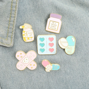 Cute cartoon medical enamel pins set on denim background with pills and band-aid designs