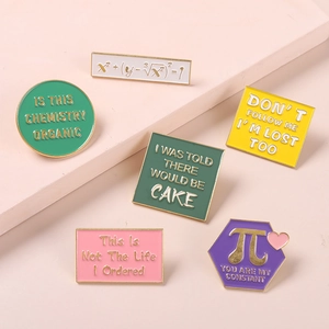 Creative enamel pin set featuring math equations and humor on minimalist surface