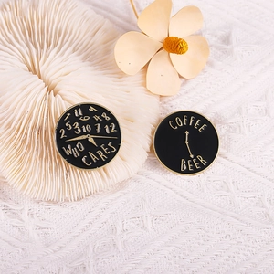 Detail of round black enamel brooches with Who Cares and Coffee Beer clock designs