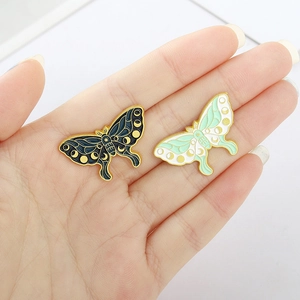 Handheld colorful butterfly enamel pins with celestial moon and star patterns