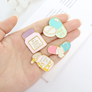 Creative enamel pin set with cute pill and bottle shapes featuring chill pill text