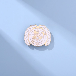 Golden UN emblem earth badge pin with white enamel world map and olive branch design