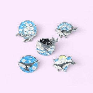 Set of 5 cute cartoon whale enamel pins featuring ocean, space and nature themes