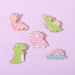 Detailed view of 5 cute macaron-colored dinosaur enamel pins on a lavender surface