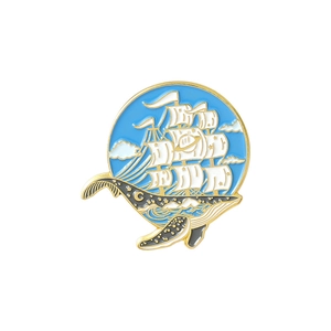 Detail of nautical enamel whale brooch with starry sky pattern and sailing ship