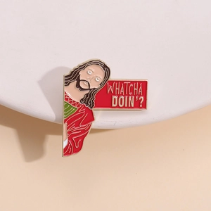 Macro detail of enamel pin featuring Jesus figure and WHATCHA DOIN text on minimalist background