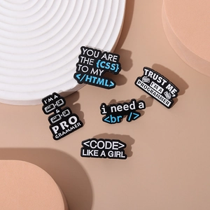 5-piece set of black enamel programmer pins featuring CSS HTML code and tech jokes