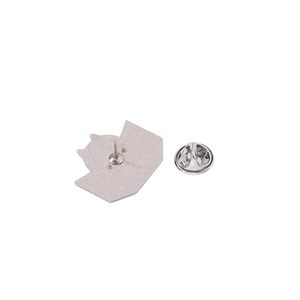 Silver metal brooch back showing textured finish and butterfly clutch pin backing