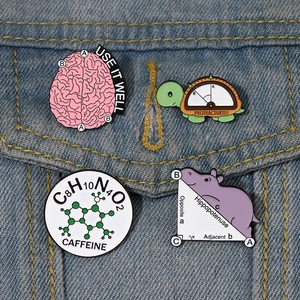 Set of four creative science and math enamel pins on a blue denim jacket pocket