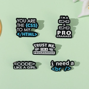 Five-piece programmer enamel pin set with CSS HTML and coding humor designs on green surface