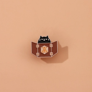 Cartoon black cat enamel brooch with D20 dice and DM screen design on pink background