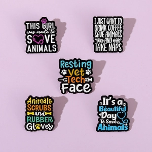 Flat lay detail of veterinary enamel pins with colorful slogans and pet paw prints