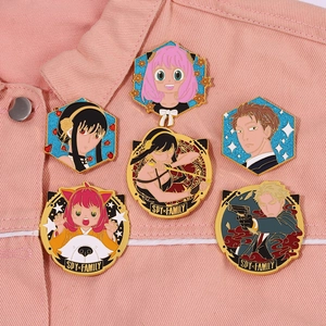 Detail of Spy x Family enamel pins featuring Anya and Yor on pink denim fabric
