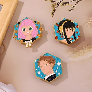 Detail of Spy x Family enamel pins featuring Anya, Yor, and Loid with blue glitter