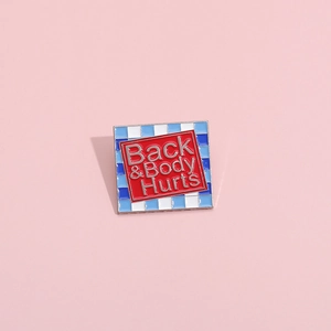 Vintage style square metal brooch with Back & Body Hurts quote on red and checkered background