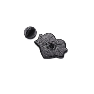 Rear view of heart wing badge showing black metal back with butterfly pin clutch