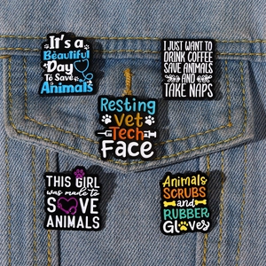 5-piece veterinary enamel pin set with colorful slogans pinned on blue denim jacket