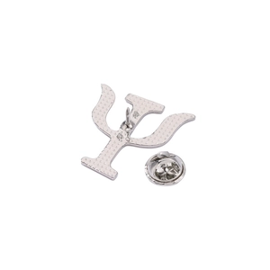 Detail view of silver Psi symbol brooch back with secure butterfly clutch closure