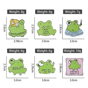 Set of six cartoon green frog enamel pins with funny English puns and size dimensions