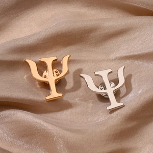 Golden and silver psychology Psi symbol lapel pins on champagne satin background