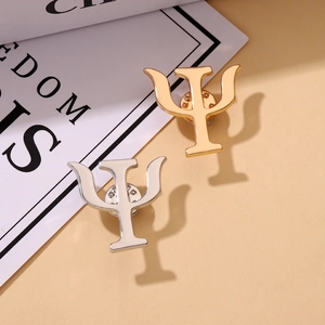 Psychology Psi symbol alloy lapel pins in gold and silver finish on a book cover