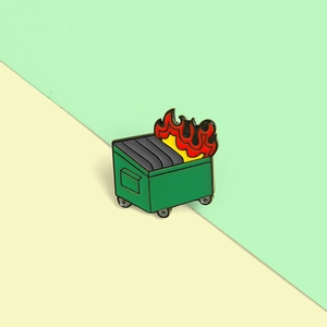 Dumpster Fire enamel pin badge with green metal and orange flame design on light background