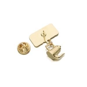 Detail view of the gold enamel coffee pot brooch back with pin and butterfly clutch
