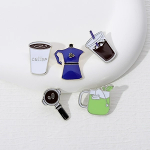 Detail view of coffee and tea enamel pins including moka pot and white coffee cup