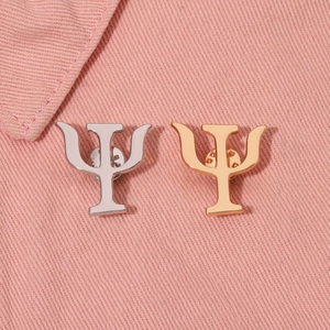 Psychology Psi symbol brooches in gold and silver finish on pink denim jacket collar