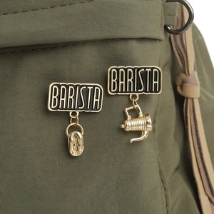 Minimalist barista brooches with coffee bean and moka pot charms on canvas fabric