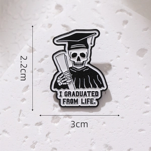 Skeletal graduate enamel pin with graduation cap and I Graduated From Life text