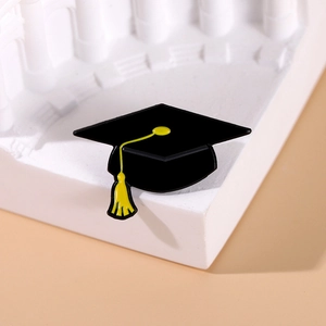 Graduation cap enamel pin with yellow tassel on white background steps for gift