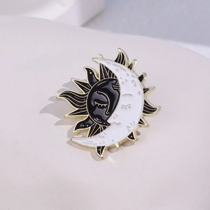 Creative sun and moon enamel brooch in black and white with gold metal plating