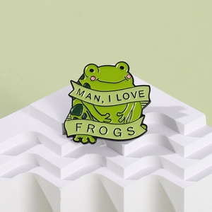 Cartoon green frog enamel pin featuring Man I Love Frogs text on white platform