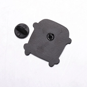 Macro view of a black enamel pin back with matte texture and rubber clutch closure