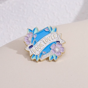 Artistic enamel book lover brooch pin featuring purple flowers and gold metal edges